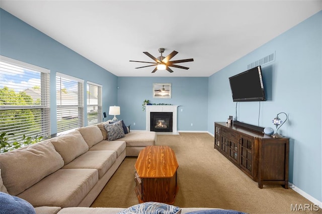 77 Brighton Park Dr, Saint Charles, MO 63303 - living room with carpet floors, ceiling fan, baseboards, and a fireplace with flush hearth