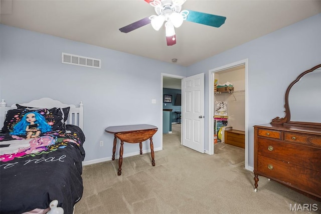 77 Brighton Park Dr, Saint Charles, MO 63303 - carpeted bedroom featuring a walk in closet, ceiling fan, a closet, and baseboards