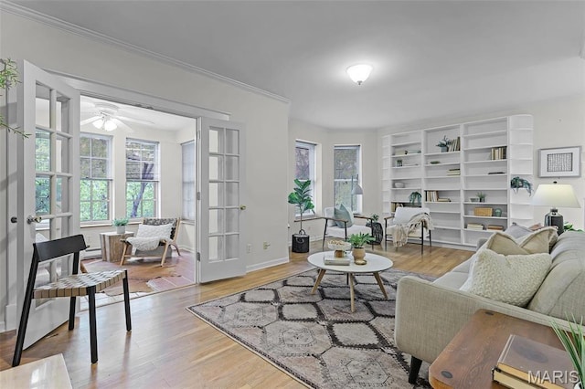 5858 Nina Pl Unit 3E, Saint Louis, MO 63112 - living room featuring healthy amount of natural light, a ceiling fan, wood finished floors, and ornamental molding