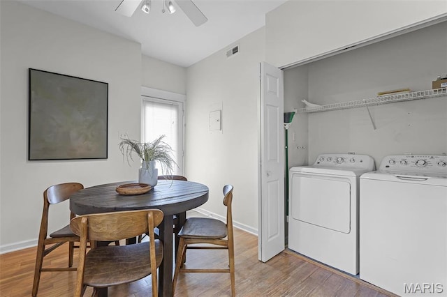 5858 Nina Pl Unit 3E, Saint Louis, MO 63112 - laundry room with light wood-type flooring, washing machine and clothes dryer, a ceiling fan, and baseboards