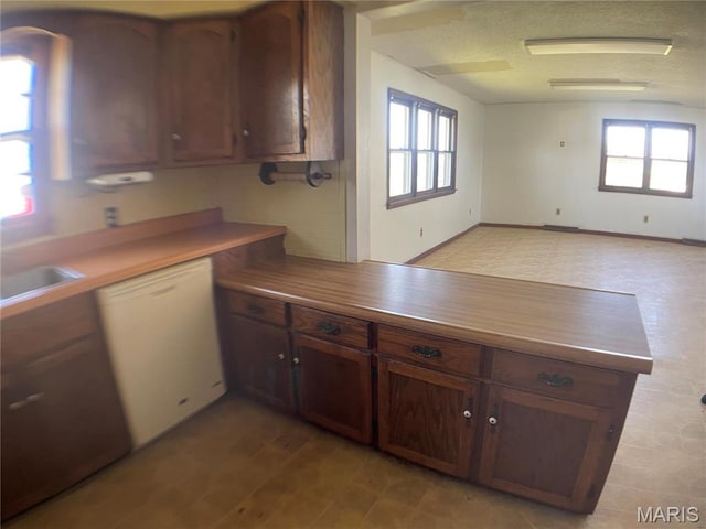 708 Locust St, Edgar Springs, MO 65462 - kitchen featuring white dishwasher, plenty of natural light, a peninsula, and a sink