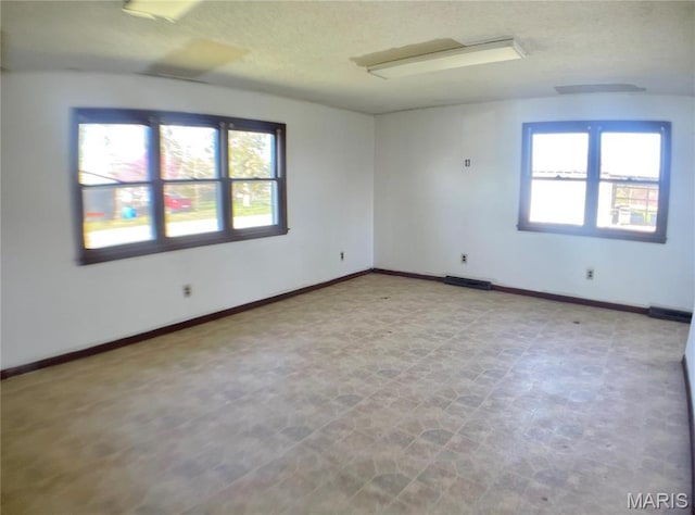 708 Locust St, Edgar Springs, MO 65462 - spare room with plenty of natural light, a textured ceiling, and baseboards