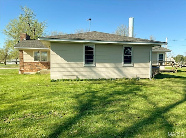 708 Locust St, Edgar Springs, MO 65462 - view of side of property featuring a lawn, a chimney, and brick siding