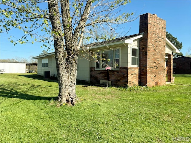 708 Locust St, Edgar Springs, MO 65462 - view of home's exterior with a chimney, cooling unit, a lawn, and brick siding
