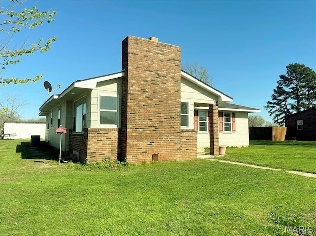 708 Locust St, Edgar Springs, MO 65462 - view of home's exterior with a chimney and brick siding