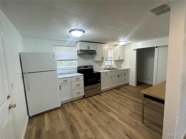 605 Foley, Poplar Bluff, MO 63901 - kitchen featuring freestanding refrigerator, stainless steel range with electric cooktop, under cabinet range hood, light wood-style flooring, and a textured ceiling