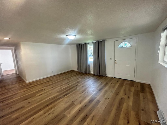 605 Foley, Poplar Bluff, MO 63901 - entrance foyer featuring a textured ceiling, wood finished floors, and baseboards