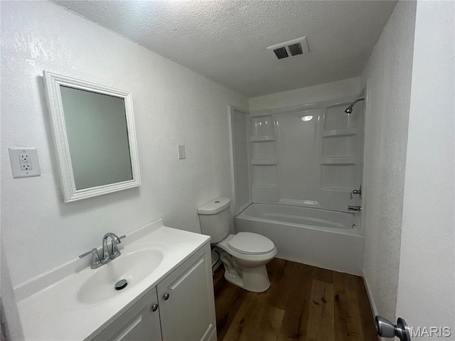 605 Foley, Poplar Bluff, MO 63901 - bathroom featuring wood finished floors, vanity, toilet, a textured ceiling, and bathing tub / shower combination