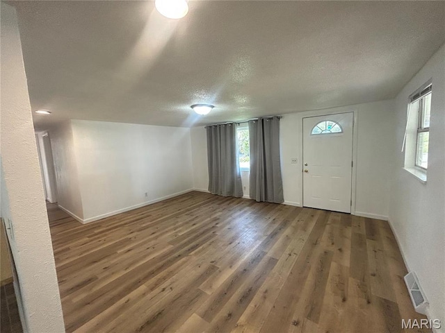 605 Foley, Poplar Bluff, MO 63901 - entryway featuring a textured ceiling, plenty of natural light, wood finished floors, and baseboards
