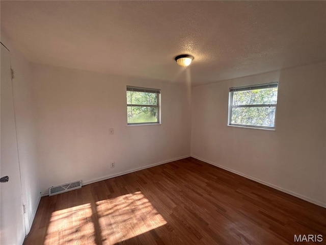 605 Foley, Poplar Bluff, MO 63901 - unfurnished room with wood finished floors, baseboards, and a textured ceiling