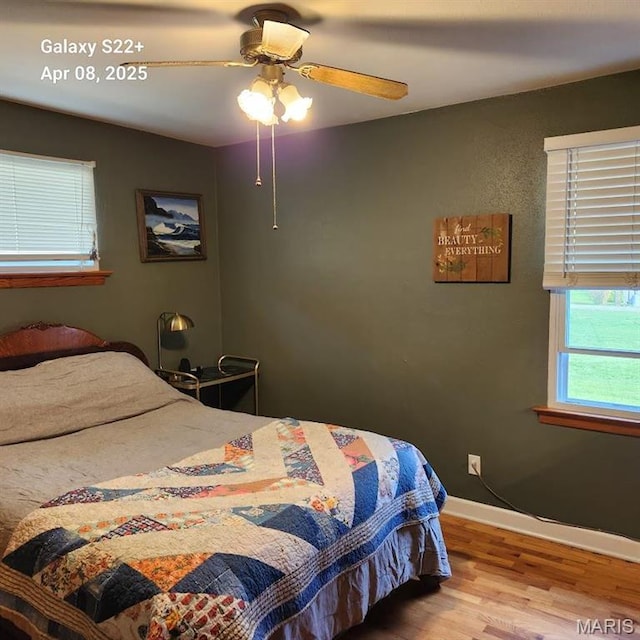 2011 Cypress St, Highland, IL 62249 - bedroom with wood finished floors, baseboards, and a ceiling fan