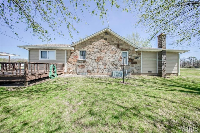 15227 County Road 1110, St James, MO 65559 - back of property with a chimney, a wooden deck, a yard, stone siding, and central AC unit
