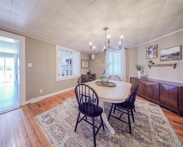 15227 County Road 1110, St James, MO 65559 - dining room featuring a chandelier, hardwood / wood-style flooring, and baseboards