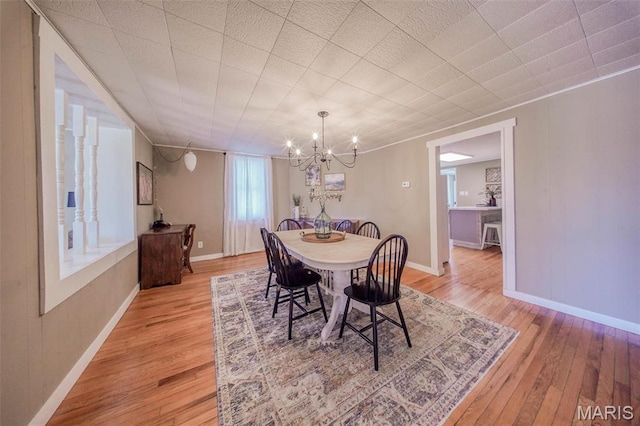 15227 County Road 1110, St James, MO 65559 - dining room with a chandelier, light wood-type flooring, and baseboards