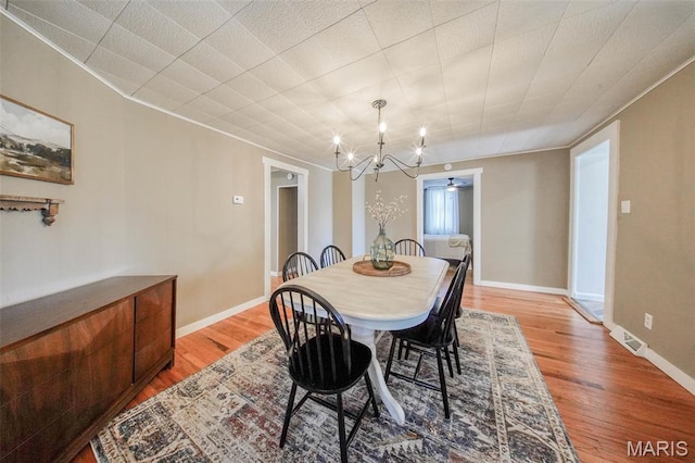 15227 County Road 1110, St James, MO 65559 - dining room with a chandelier, light wood finished floors, and baseboards