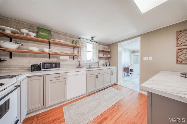 15227 County Road 1110, St James, MO 65559 - kitchen featuring open shelves, white appliances, a sink, light wood-type flooring, and tasteful backsplash