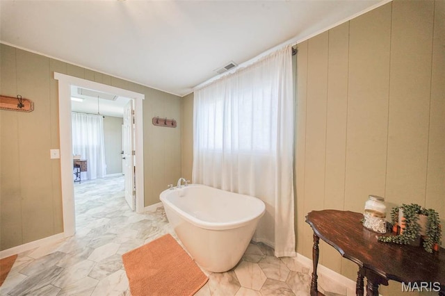 15227 County Road 1110, St James, MO 65559 - bathroom featuring a freestanding bath and a decorative wall