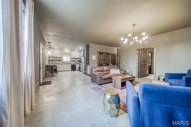 15227 County Road 1110, St James, MO 65559 - living area with finished concrete floors and a chandelier