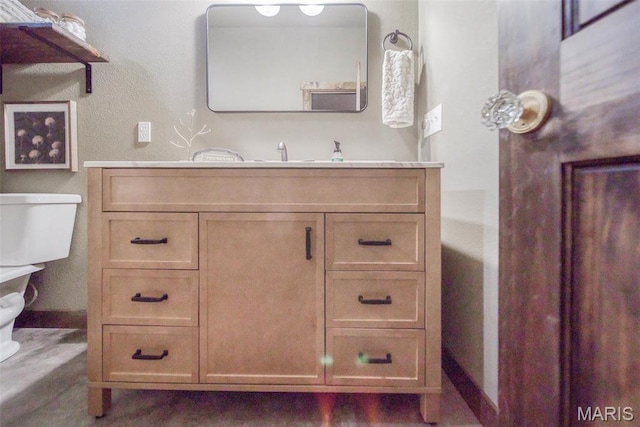 15227 County Road 1110, St James, MO 65559 - bathroom featuring toilet, vanity, baseboards, and a bathtub