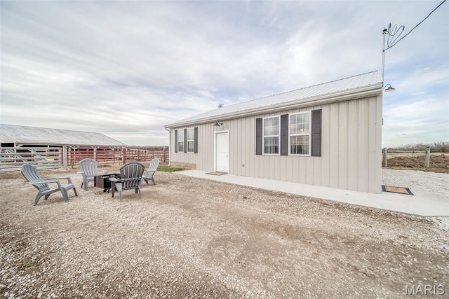 15227 County Road 1110, St James, MO 65559 - back of property featuring metal roof, fence, and an outbuilding