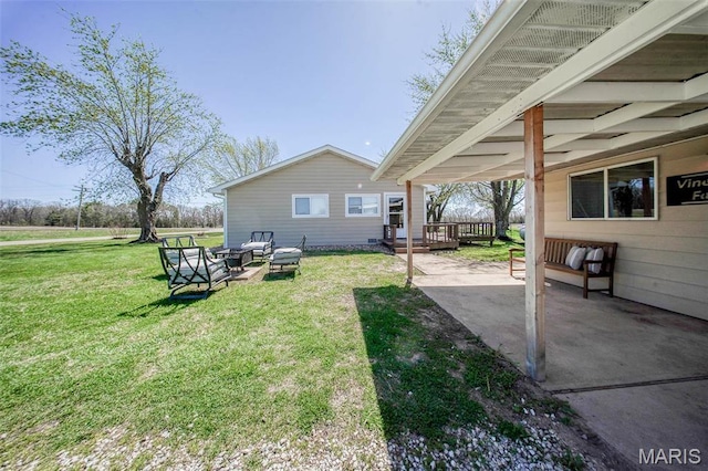 15227 County Road 1110, St James, MO 65559 - view of green lawn with a patio area, a wooden deck, and a carport