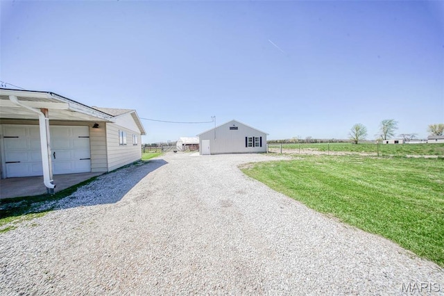 15227 County Road 1110, St James, MO 65559 - view of side of property featuring driveway, a yard, and an outdoor structure
