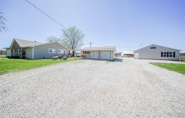 15227 County Road 1110, St James, MO 65559 - view of front facade featuring a detached garage, an outdoor structure, and a front lawn
