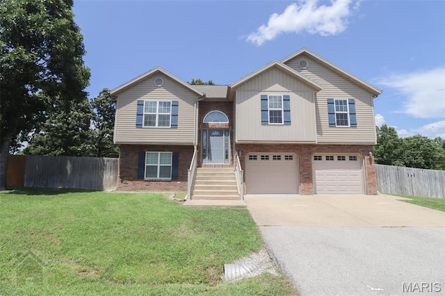 23332 Righteous Ln, Waynesville, MO 65583 - raised ranch featuring brick siding, an attached garage, and concrete driveway
