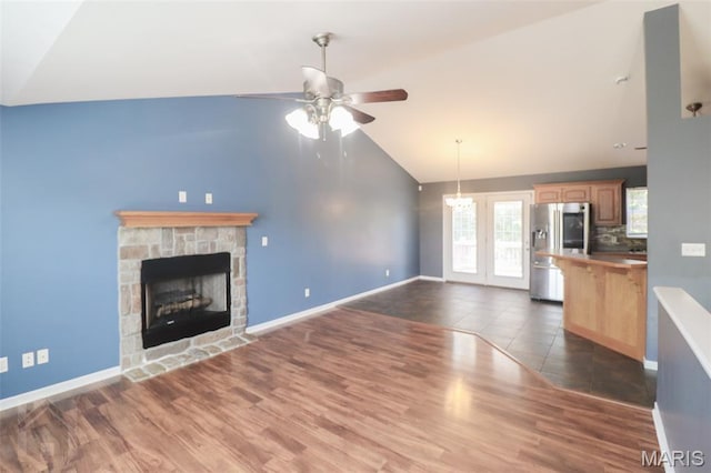 23332 Righteous Ln, Waynesville, MO 65583 - unfurnished living room featuring a ceiling fan, a fireplace, dark wood finished floors, and high vaulted ceiling