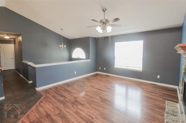 23332 Righteous Ln, Waynesville, MO 65583 - unfurnished room with a ceiling fan, vaulted ceiling, dark wood-type flooring, and a chandelier