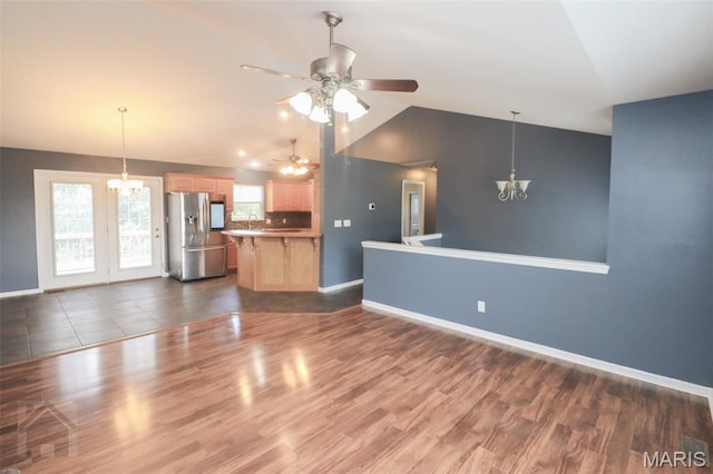 23332 Righteous Ln, Waynesville, MO 65583 - unfurnished living room featuring a chandelier, lofted ceiling, ceiling fan, and dark wood-style floors