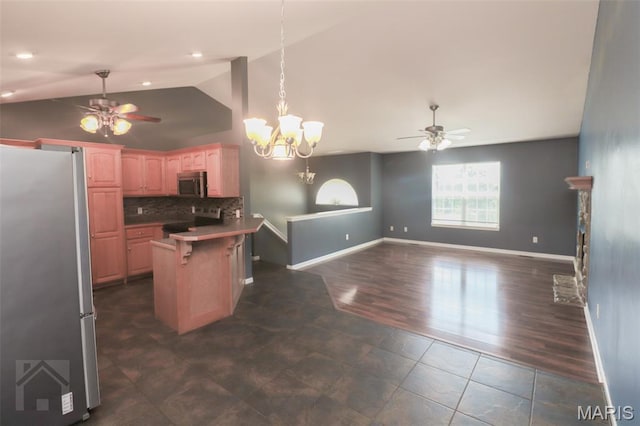 23332 Righteous Ln, Waynesville, MO 65583 - kitchen with appliances with stainless steel finishes, ceiling fan, lofted ceiling, a chandelier, and a kitchen bar
