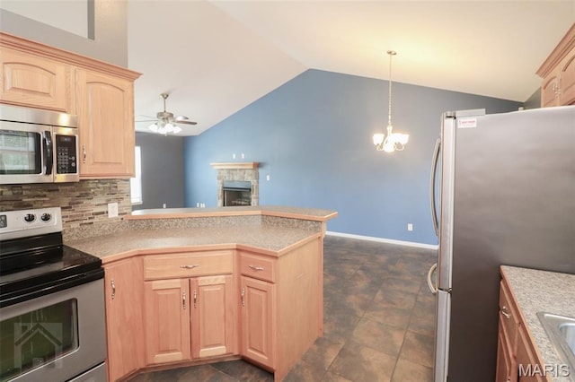 23332 Righteous Ln, Waynesville, MO 65583 - kitchen featuring appliances with stainless steel finishes, light brown cabinetry, vaulted ceiling, a ceiling fan, and a peninsula