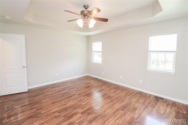 23332 Righteous Ln, Waynesville, MO 65583 - empty room featuring a raised ceiling, wood finished floors, a ceiling fan, and a smoke detector