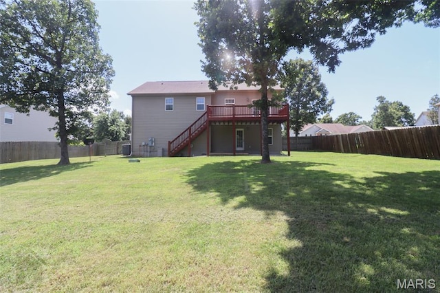 23332 Righteous Ln, Waynesville, MO 65583 - back of property featuring stairway, a wooden deck, and a fenced backyard
