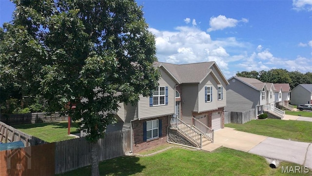 23332 Righteous Ln, Waynesville, MO 65583 - split foyer home with an attached garage, driveway, and brick siding