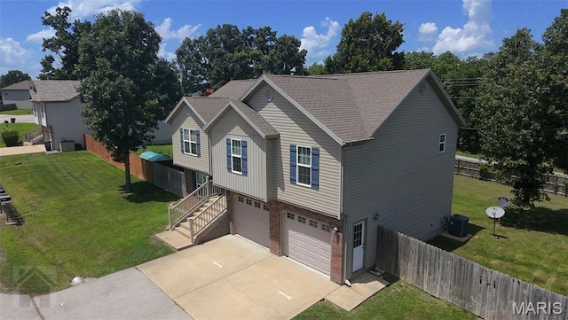 23332 Righteous Ln, Waynesville, MO 65583 - view of front facade with concrete driveway, an attached garage, stairway, brick siding, and a shingled roof