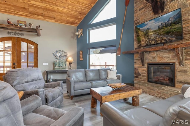 1318 Stormy Point Rd Unit 7, Branson, MO 65616 - living area featuring high vaulted ceiling, wood finished floors, wooden ceiling, arched walkways, and a stone fireplace