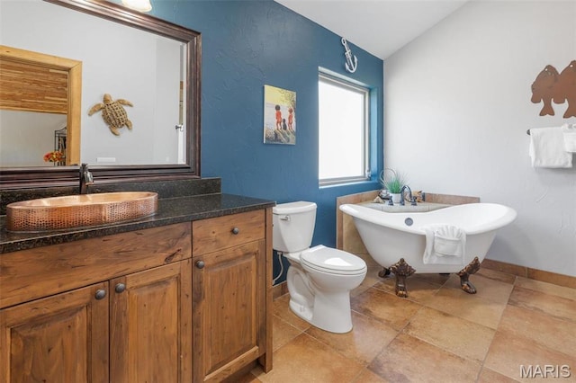 1318 Stormy Point Rd Unit 7, Branson, MO 65616 - full bathroom featuring toilet, a freestanding bath, vaulted ceiling, vanity, and baseboards