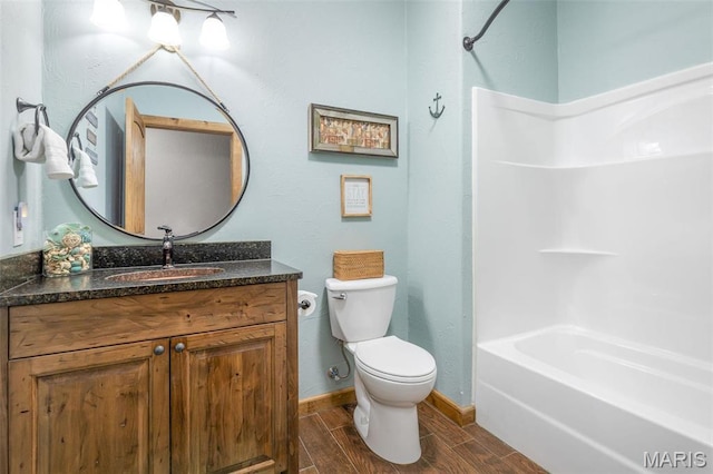 1318 Stormy Point Rd Unit 7, Branson, MO 65616 - bathroom featuring toilet, wood finish floors, vanity, baseboards, and  shower combination