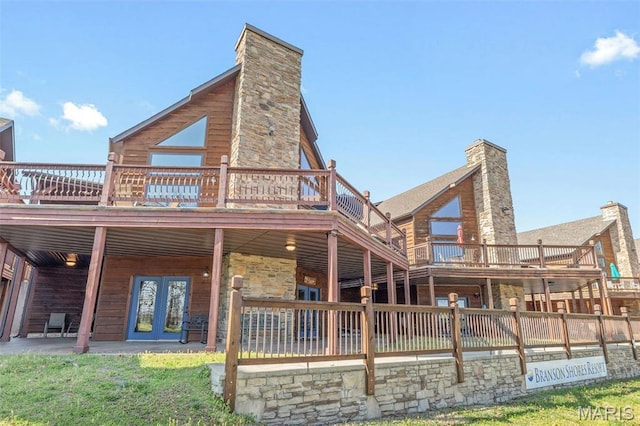 1318 Stormy Point Rd Unit 7, Branson, MO 65616 - back of house featuring a chimney, a wooden deck, stone siding, and french doors