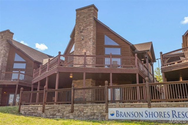1318 Stormy Point Rd Unit 7, Branson, MO 65616 - rear view of house with a chimney, a deck, and roof with shingles
