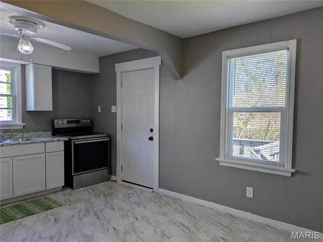 330 N Floridale Ave, Saint Louis, MO 63135 - kitchen featuring electric stove, a sink, light marble finish flooring, a ceiling fan, and white cabinets