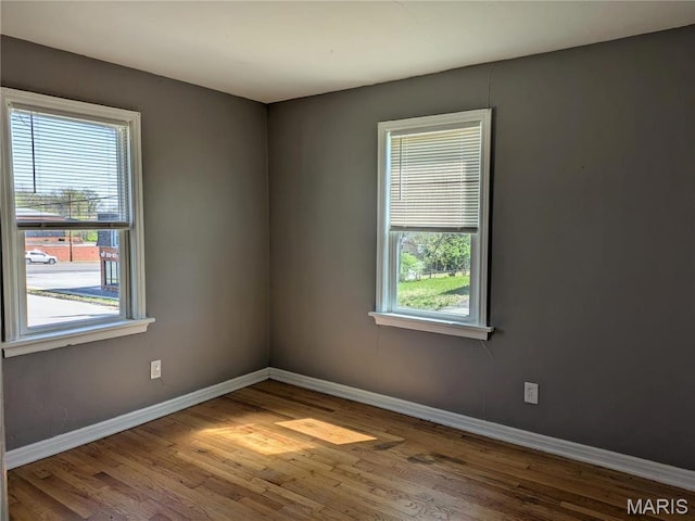 330 N Floridale Ave, Saint Louis, MO 63135 - spare room featuring baseboards and wood finished floors
