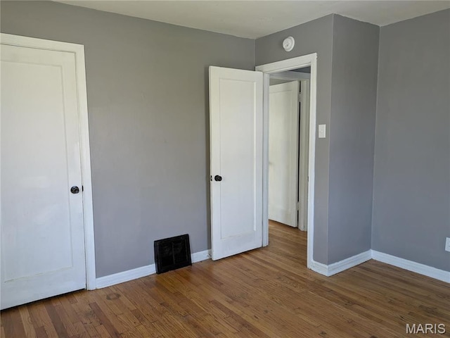 330 N Floridale Ave, Saint Louis, MO 63135 - unfurnished bedroom with baseboards and wood finished floors