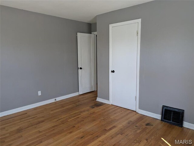 330 N Floridale Ave, Saint Louis, MO 63135 - unfurnished room featuring wood finished floors and baseboards
