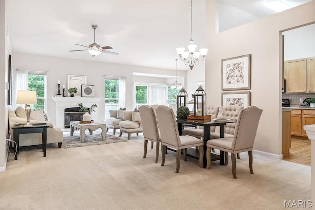 104 Eagle Cove Pl Unit 39B, Saint Charles, MO 63303 - dining room with light carpet, a chandelier, a ceiling fan, a fireplace, and lofted ceiling