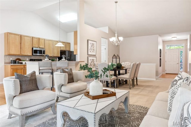 104 Eagle Cove Pl Unit 39B, Saint Charles, MO 63303 - living room with a chandelier, lofted ceiling, baseboards, and light carpet