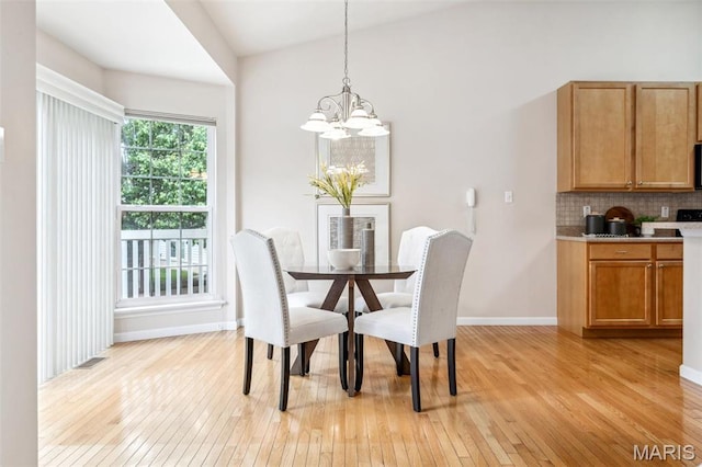 104 Eagle Cove Pl Unit 39B, Saint Charles, MO 63303 - dining room with light wood finished floors, a chandelier, and baseboards