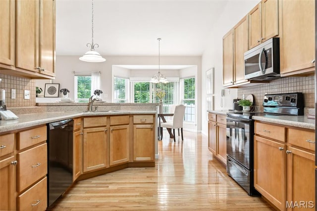 104 Eagle Cove Pl Unit 39B, Saint Charles, MO 63303 - kitchen featuring black appliances, light wood-type flooring, light countertops, and tasteful backsplash